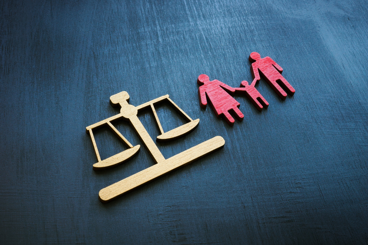 Family law concept. Figures of small scales and families for adoption.